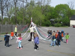 kids dancing around the maypole