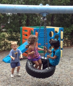 kids playing on tire swing